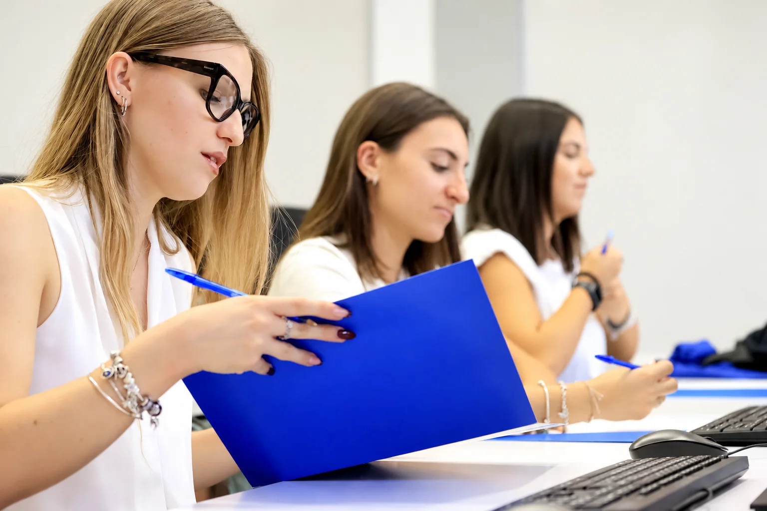 Pre-health students taking notes in a bright university classroom